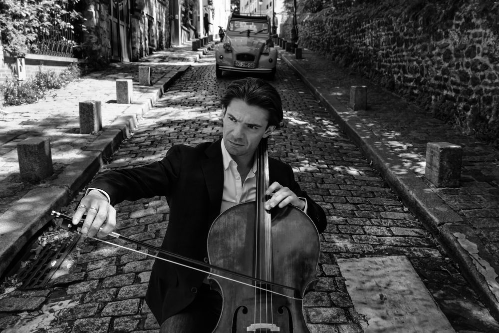Gautier Capuçon playing cello on a street
